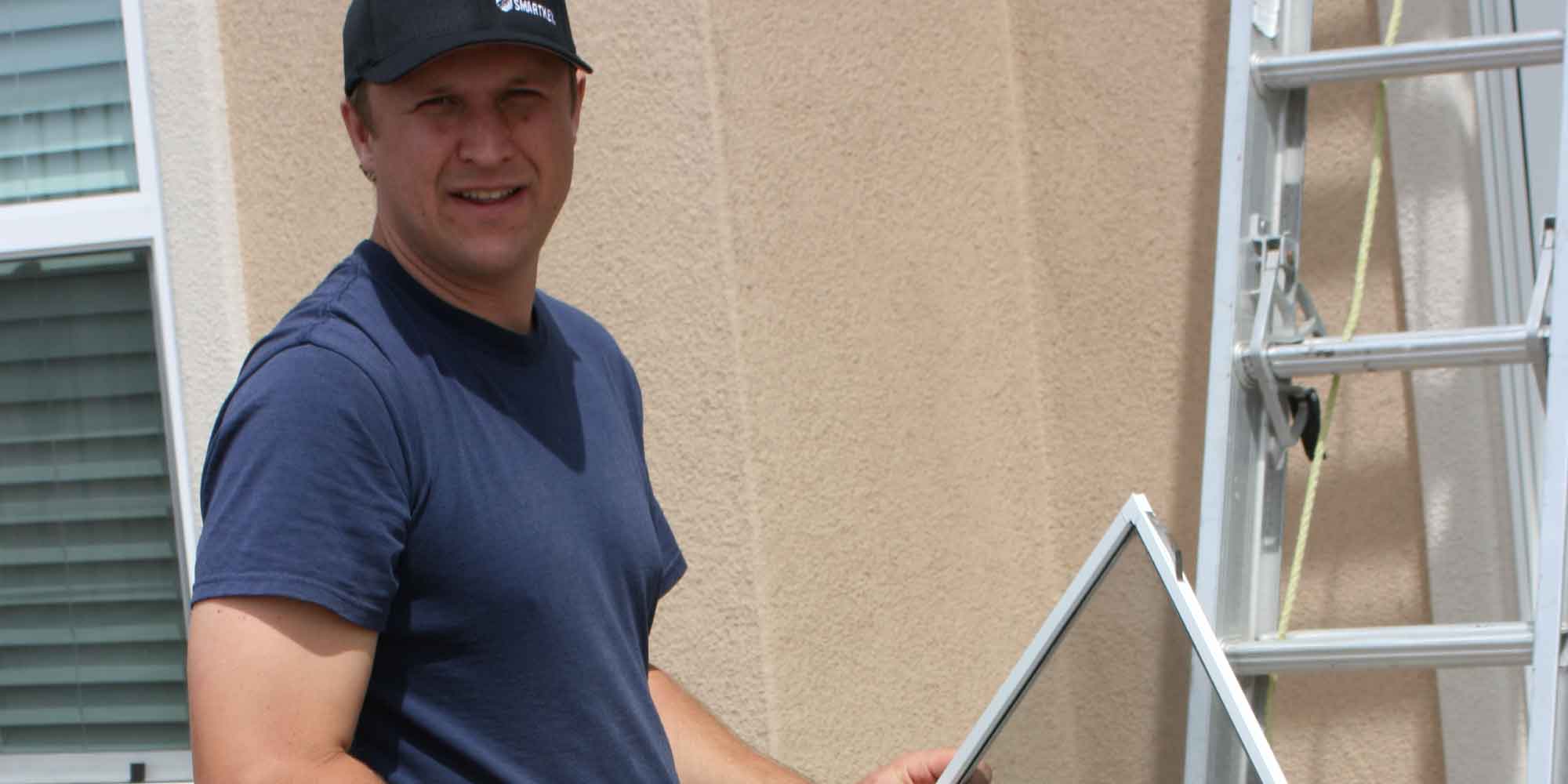 Owner holding a window screen during service work